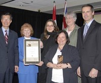 Karen Luttrell and Lori Nash are among representatives accepting a June Callwood Award from Ontario Premier Dalton McGuinty on behalf of the Friends of the Ottawa Public Library Association